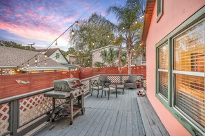Enjoy al fresco dining on the patio, complete with a grill, chairs, and table.