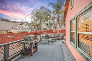 Enjoy al fresco dining on the patio, complete with a grill, chairs, and table.