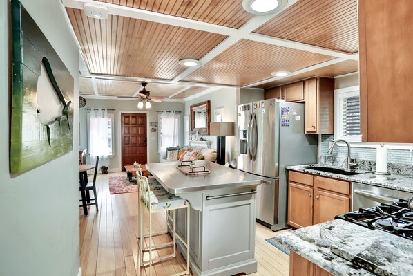 Kitchen with central island, stainless steel appliances, and wooden cabinetry.