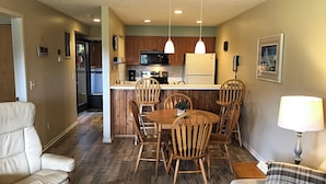 A compact living space with a dining area, kitchen, and seating.