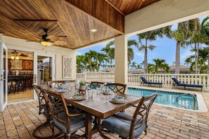 Outdoor dining - Striking European-style home w/ private pool, hot tub & river access via dock (Cape Coral)