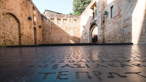 A courtyard with stone walls and an open area with engraved text. - Quercy cottage, charm, comfort, garden with trees, natural swimming pool (Frontenac)