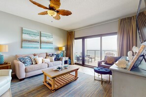 Relax in a cozy seating area with a sofa and coffee table, and enjoy the view from the balcony.