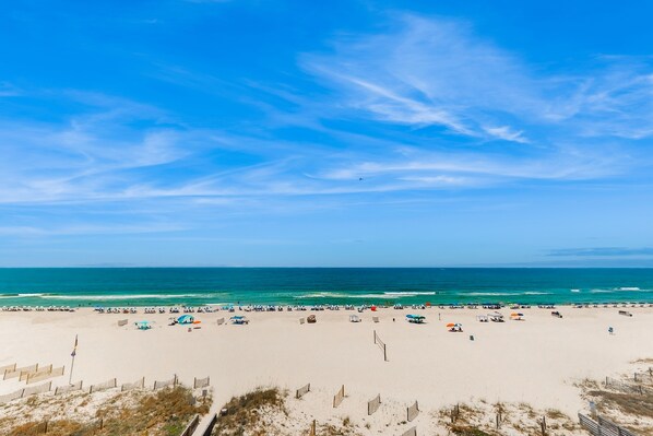 Relax on the beach with comfortable seating and shade.