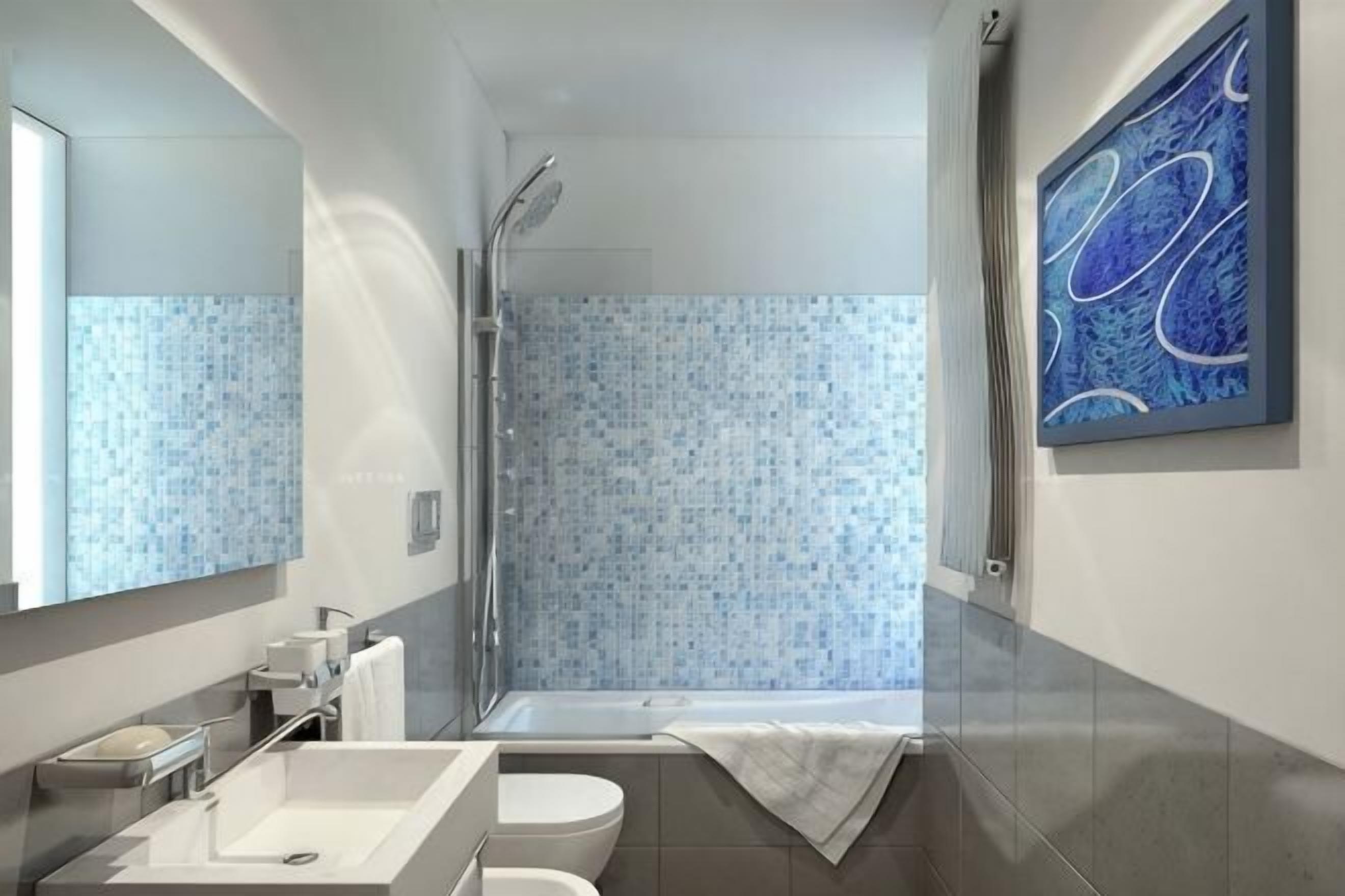 A modern bathroom with a shower, two sinks, and a large mirror.