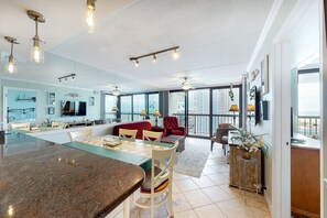 Relax in this stylish living area with a central island, sofa, and dining table, perfect for socializing or unwinding.