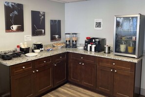 Enjoy cooking and dining in this fully equipped kitchen with a coffee station, refrigerator, and microwave.