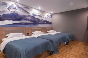 A hotel room with two beds, a large mural on the wall, and wooden flooring. - Meng Zhi Dao Hotel (Loudi)