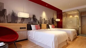 A hotel room with two beds, a red chair, a wall-mounted light, and a door. - Shankee Chain Hotel (Shenzhen Longhua Qinghu Subway Station) (Shenzhen)