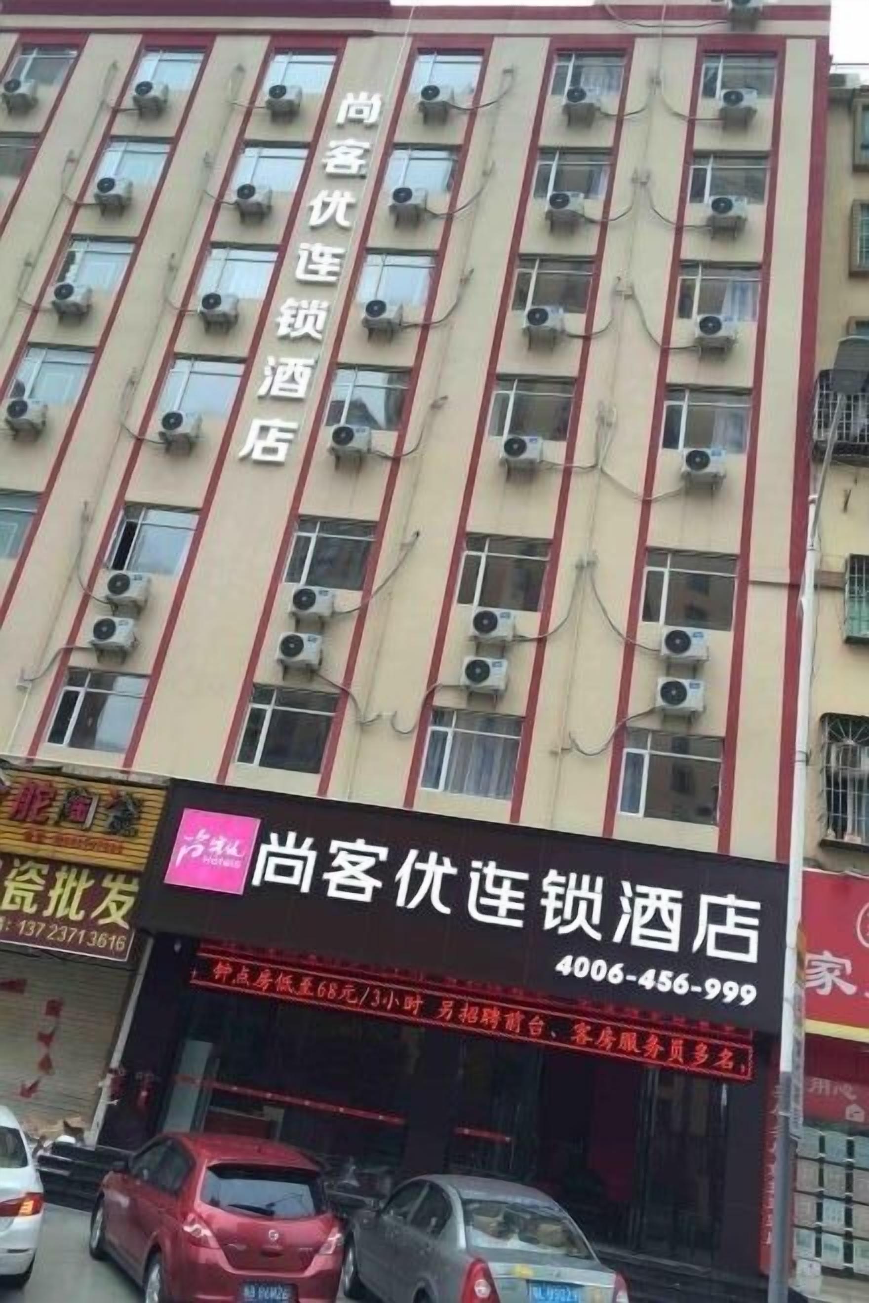 A hotel building with multiple air conditioning units on the facade.