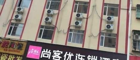 A hotel building with multiple air conditioning units on the facade.