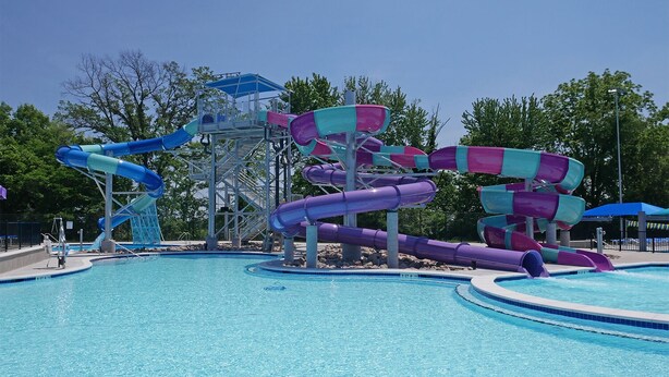 A water park with multiple water slides and a swimming pool.