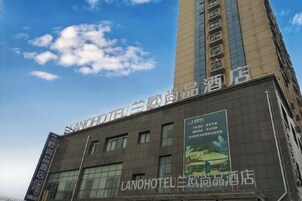 Un edificio de hotel con señalización que indica que es un hotel y un nombre de marca.