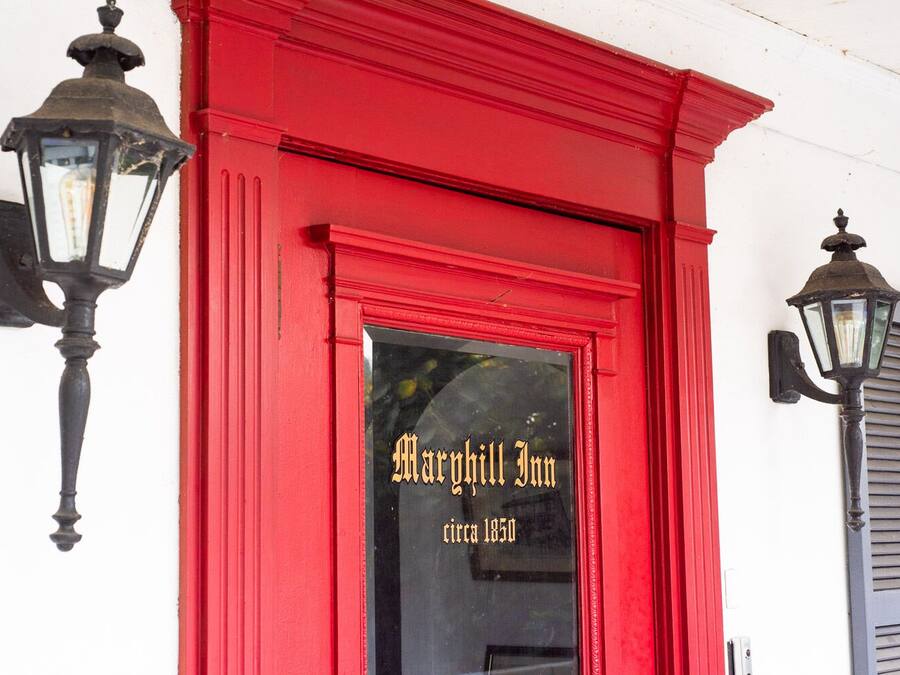 A red building with the sign "Margaret Inn circa 1850" on the entrance.