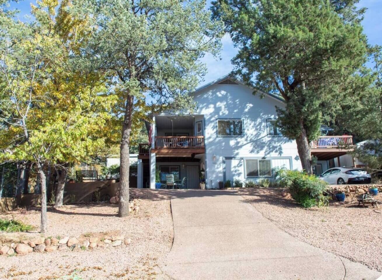 A two-story house with a front porch, a garage, and a driveway.