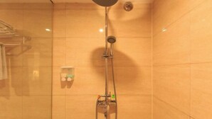 A shower with a handheld showerhead and a wall-mounted faucet. - Rongshui Miaoshan International Hotel (Liuzhou)