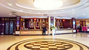 A hotel lobby with a central reception desk, a chandelier, and a checkered floor design. - Rongshui Miaoshan International Hotel (Rongshui)