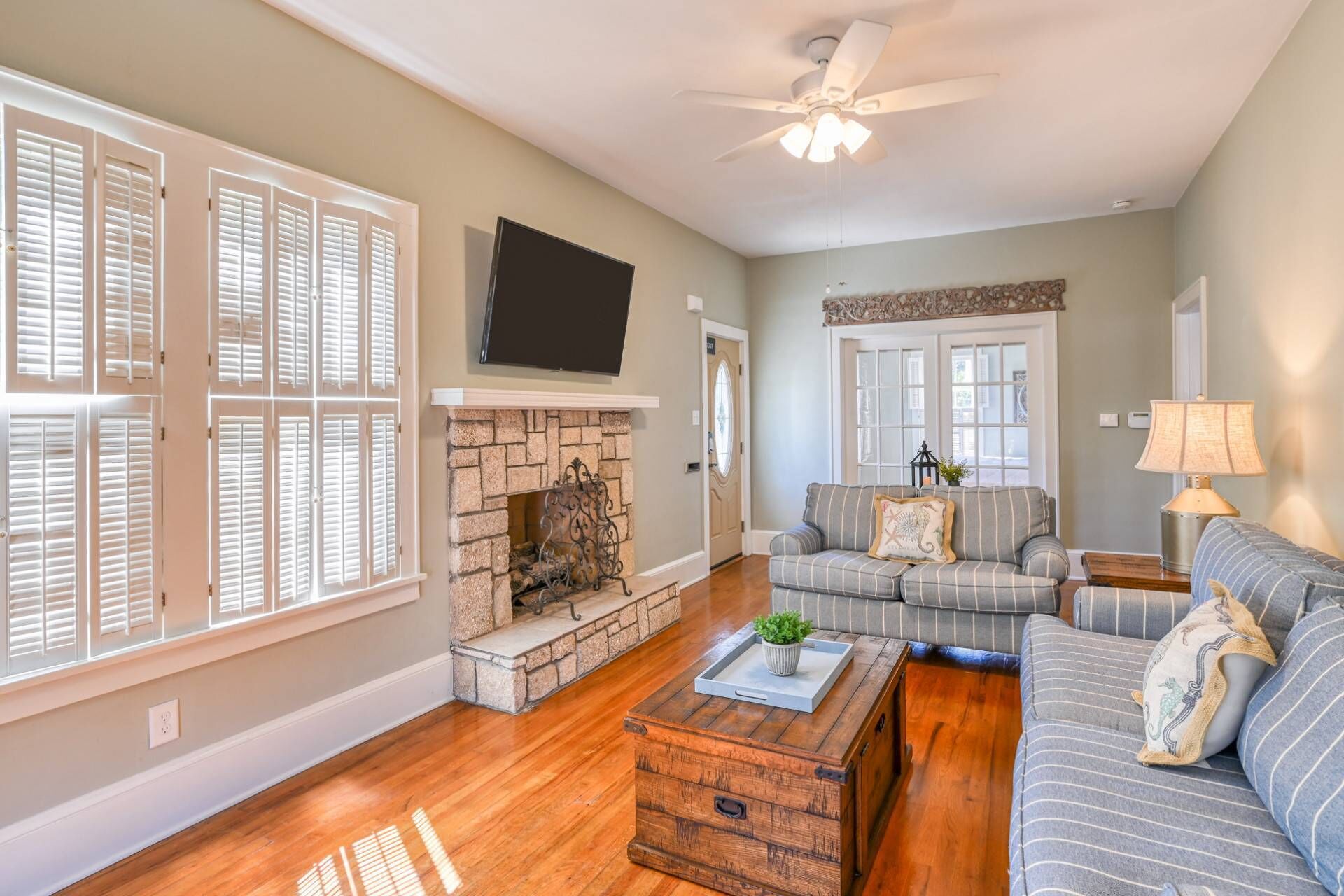 A living room with a fireplace, a sofa, a coffee table, and a television.