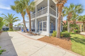 A two-story building with a balcony, surrounded by palm trees and a well-maintained lawn. - FREE Beach Setup on PRIVATE BEACH ♥ Beach Bar Pavilion ♥ Two Pools, Pickleball (Miramar Beach)