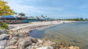 A beachside restaurant with outdoor seating and a view of the ocean. - 3260 Little Harbor (Ruskin)