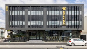 A modern hotel building with a prominent "GOLDEN HOTEL" sign. - Golden Hotel (Christchurch)