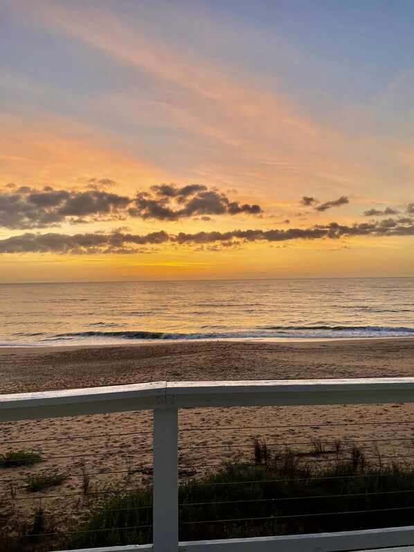 A beach view with a railing in the foreground. - Oceanfront Escape, Grill, Hammocks, Fire Pit, & Stunning Views (Ponte Vedra Beach)
