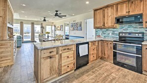 A spacious kitchen with wooden cabinets, a built-in microwave, and a double oven. - Coastal Home: Walk to Holden Beach! (Holden Beach)