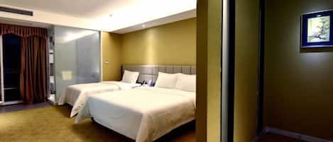 A hotel room with two beds, a large mirror, and a view of the hallway.