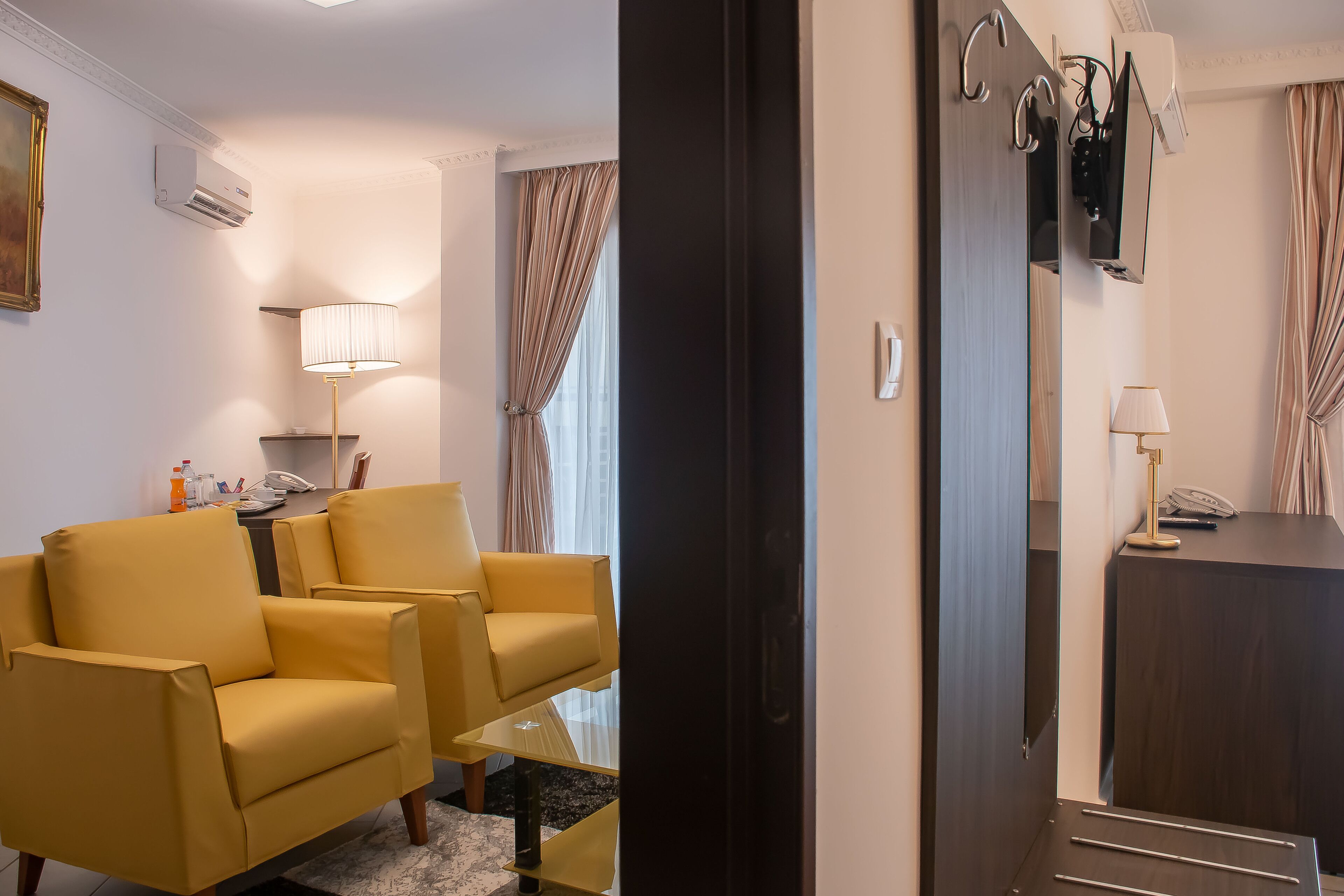 deluxe suite | living area | 43-inch smart tv with digital channels, tv, smart speakers