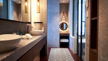 A modern bathroom with two large sinks, a mirror, and a patterned floor.