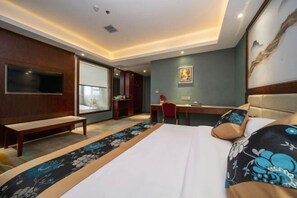 A hotel room with a bed, a desk, a chair, a bench, a TV, and a large window. - Aishang Hotel (Ji'an People's Square Branch) (Ji'an)