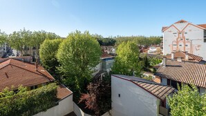 A residential area with terracotta-tiled roofs, white buildings, and lush greenery. - "Charming Apt near Casino & Beach, Parking, Balcony, Shops Nearby" (Arcachon)