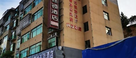 A multi-story building with signage for a hotel and a restaurant.