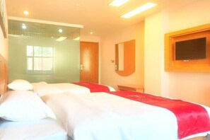 A hotel room with two beds, a TV mounted on the wall, and a glass door leading to a bathroom. - Shankee Hotel (Ningdu Third Ring South Road) (Ganzhou)