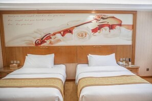 A hotel room with two beds, a wooden headboard, and a large framed picture of a violin and roses. - Vienna International Hotel (Yushan Sanqing Square) (Yushan)