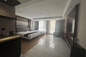 A hotel room with a large bed, a desk, a TV, and a view of the outdoors. - Renhe International Hotel (Jarud Banner)