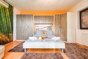 A modern bedroom with a bed, a wardrobe, and a large window. - Twin Oasis Retreat With Pool & Spa (Sveti Ivan Zelina)