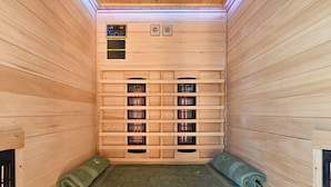 A sauna with wooden walls, a bench, and a control panel. - Twin Oasis Retreat With Pool & Spa (Sveti Ivan Zelina)