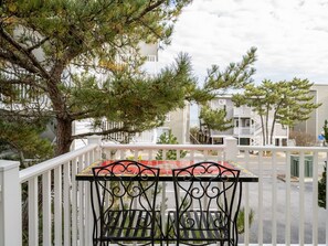 A balcony with a metal railing and a small table. - Stunning home Ocean Block in Desirable North Ocean City (Ocean City)