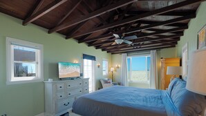 A bedroom with a bed, dresser, TV, and windows. - 1205O Spanish Beach Bungalow Retreat (Oxnard)