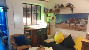 Un salon confortable avec un canapé, une table basse et un coin repas comprenant une table et des chaises.