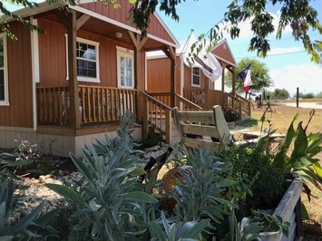 Alamo cabin in forefront.  We have several other cabins and camping too