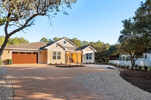A single-story house with a garage, a front porch, and a driveway.