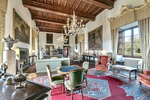 A spacious room with a high wooden ceiling, ornate chandeliers, and a large window with curtains. - VILLA GRANDUCA - Six Bedroom Villa, Sleeps 12 (Pistoia)