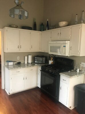 Enjoy cooking in this fully equipped kitchen with a gas stove, microwave, and toaster oven.