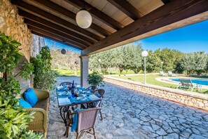 Enjoy dining al fresco under a shaded pergola overlooking the pool and beautifully landscaped garden.