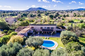 Relax in a serene outdoor space surrounded by lush greenery and rolling hills.