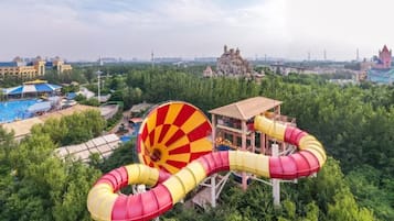 A water park with a large spiral slide and a castle-like structure in the background.