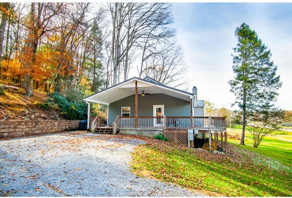 A two-story house with a porch, a garage, and a driveway.