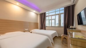 A hotel room with two beds, a desk, a chair, a TV, and a window with curtains. - Jiabaihe Hotel (Buyong Subway Station Branch) (Shenzhen)